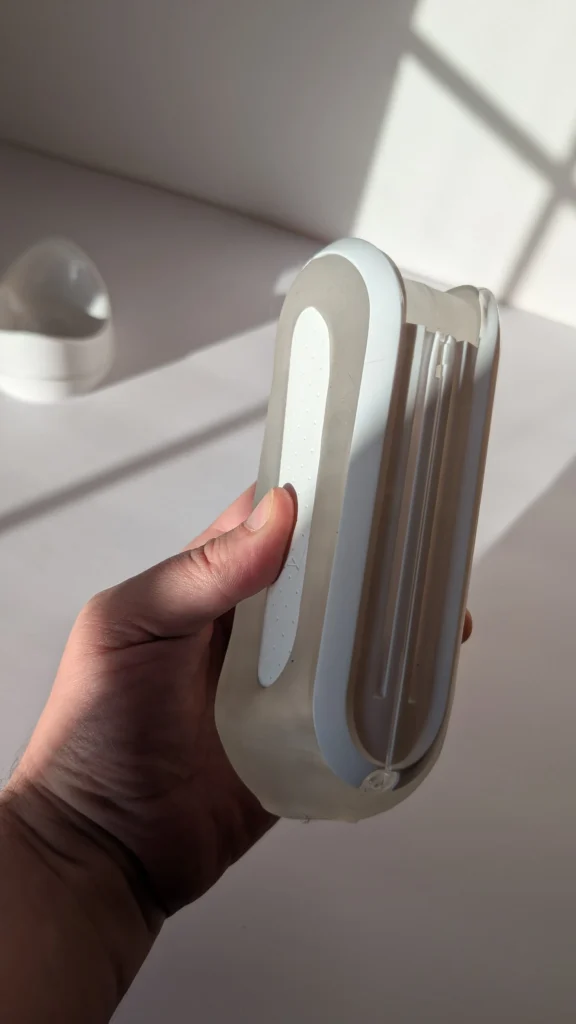 Tenga Flip Zero held in hand after 31 test sessions, side view of the clear shell