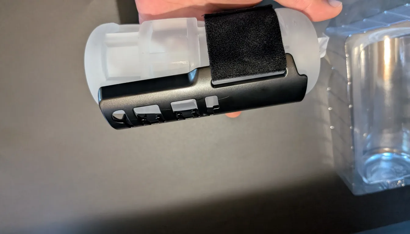 Solace Pro Grip Kit held sideways, showing the black holder, hook-and-loop band and clear windowed sleeve
