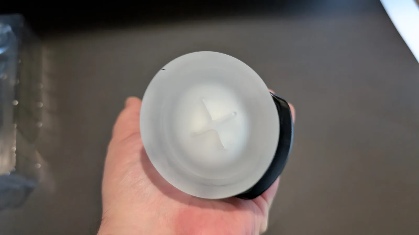 End view of the clear grip sleeve showing the cross-shaped slit