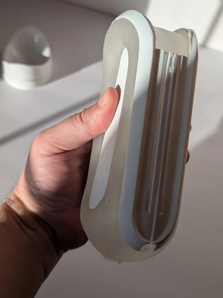 Tenga Flip Zero held in one hand, showing its slim profile